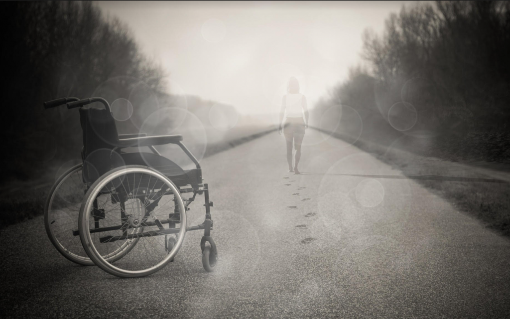 A woman walking in front of her wheelchair