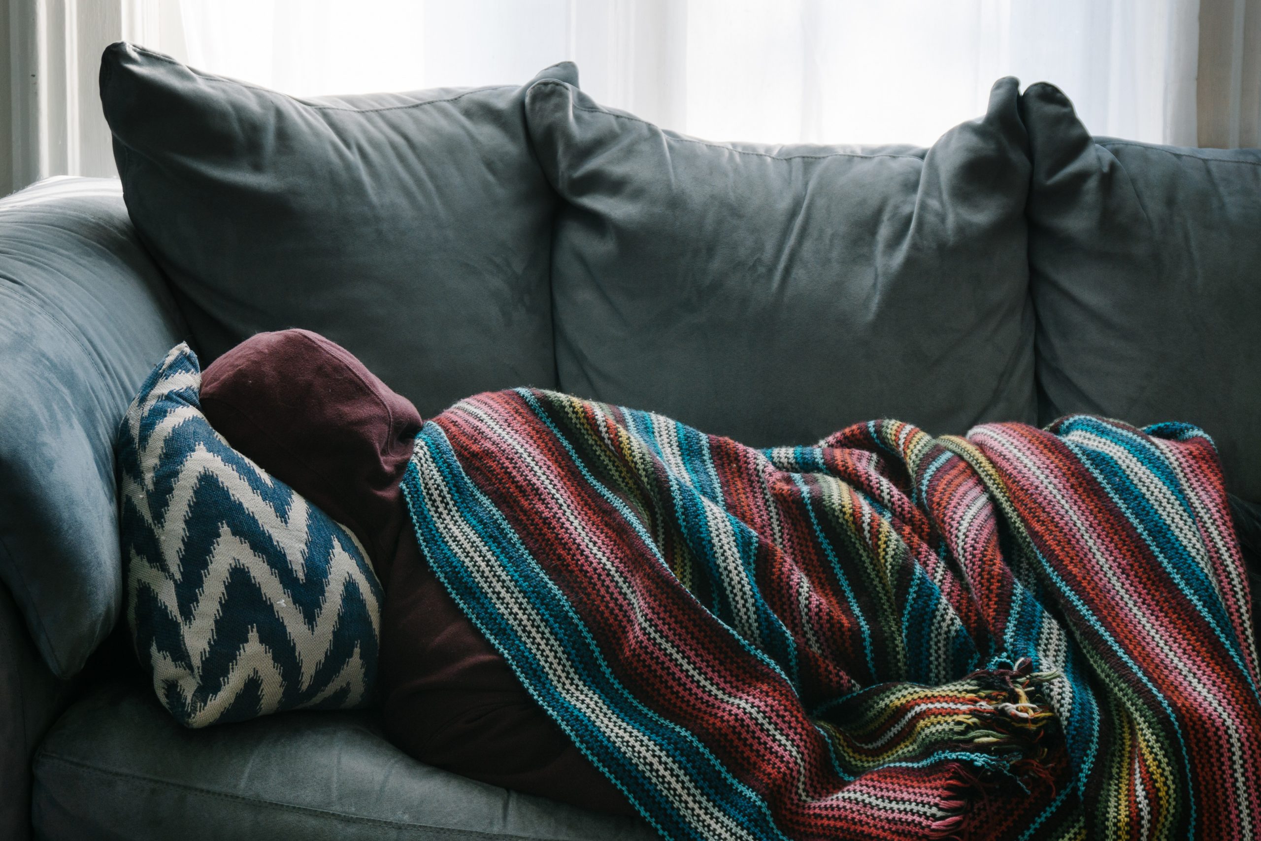 Image of sick woman on couch with lupus